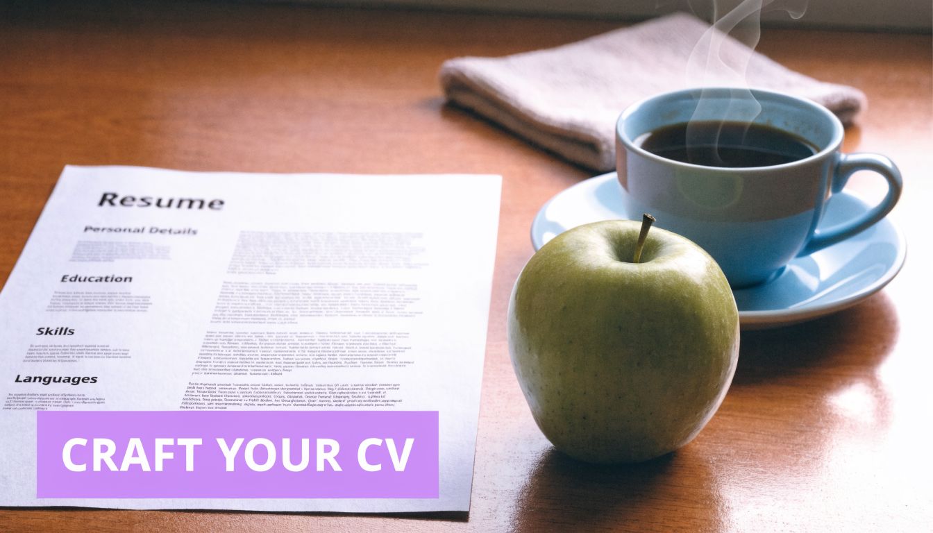 A printed resume sits on a wooden desk next to a steaming cup of coffee and an apple.