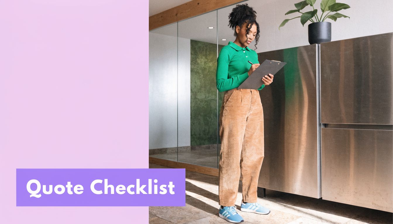 A professional woman in a green sweater and corduroy pants writing on a clipboard in an office
